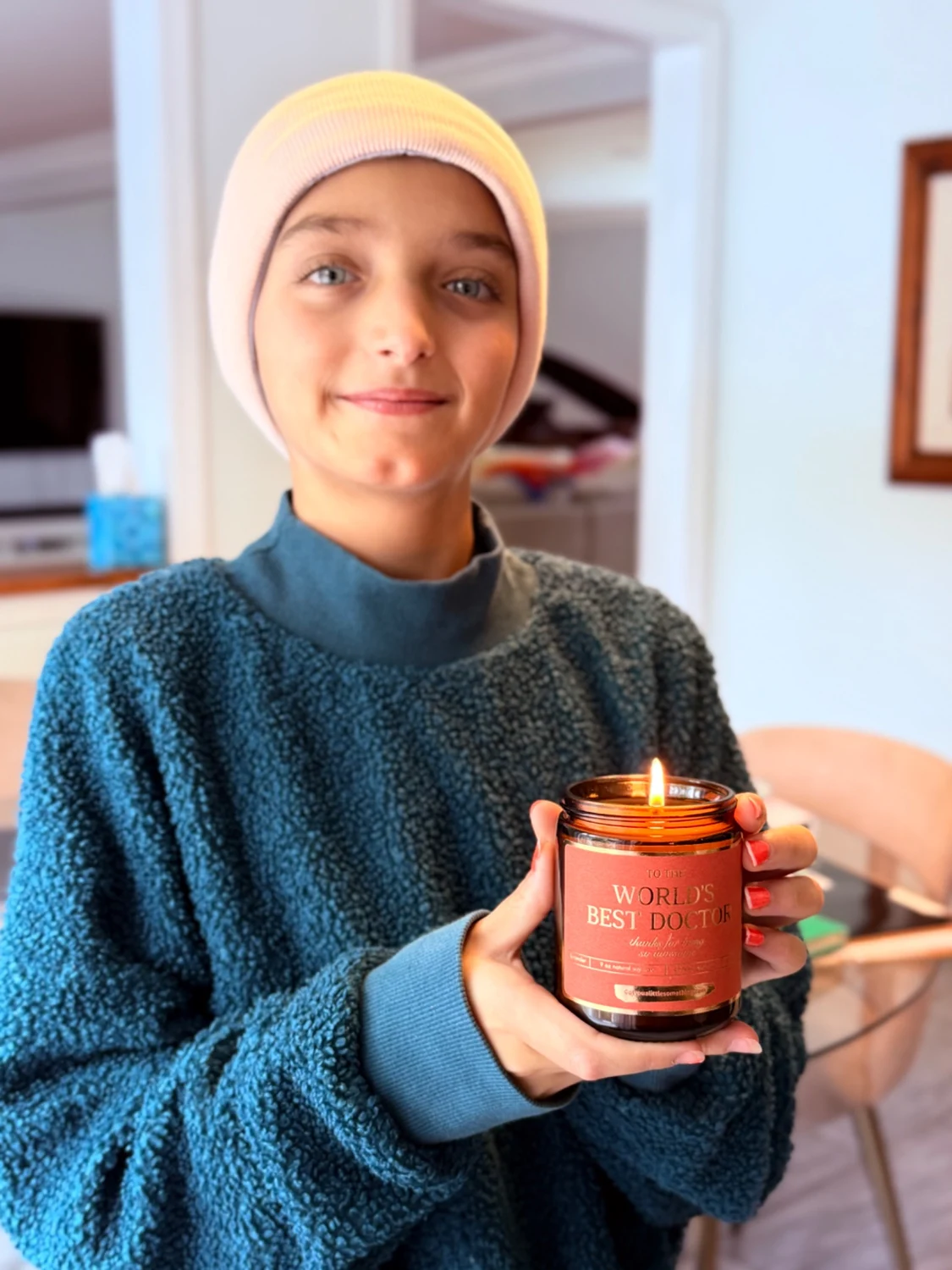 Sophia holding a lit World’s Best Doctor candle